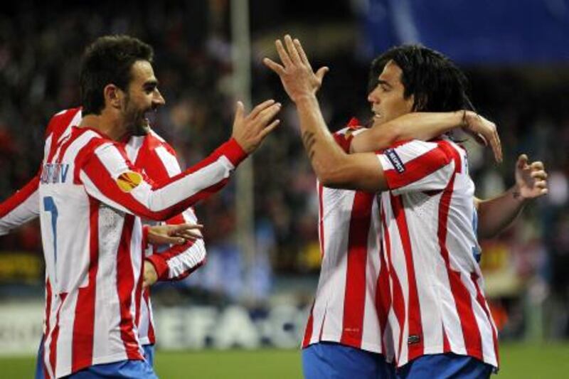 MADRID, SPAIN - APRIL 19:  Radamel Falcao of Atletico Madrid celebrates with team mate Adrian Lopez (L) after scoring the opening goal during the UEFA Europa League Semi Final first leg match between Atletico Madrid and Valencia at Vicente Calderon stadium on April 19, 2012 in Madrid, Spain.  (Photo by Angel Martinez/Getty Images)