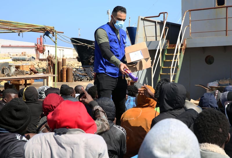 Snacks are distributed among the rescued migrants in Tripoli. AFP