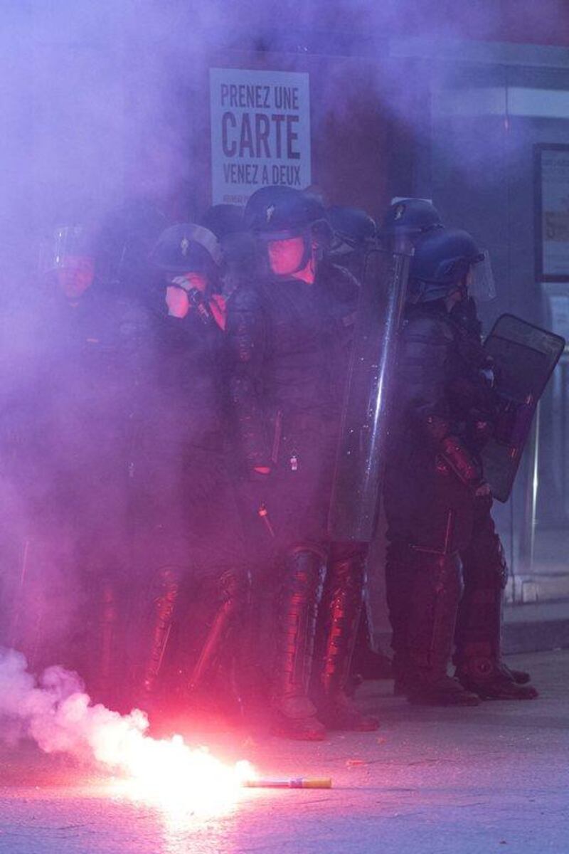 French gendarmes stand guard in front of the Paris Saint-Germain shop at the Champs Elysees in Paris on Wednesday after PSG clinched the Ligue 1 title. Kenzo Tribouillard / AFP / May 7, 2014