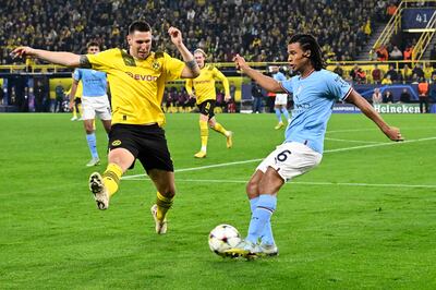 Manchester City's Nathan Ake clears the ball under pressure from Borussia Dortmund's Niklas Suele. AFP