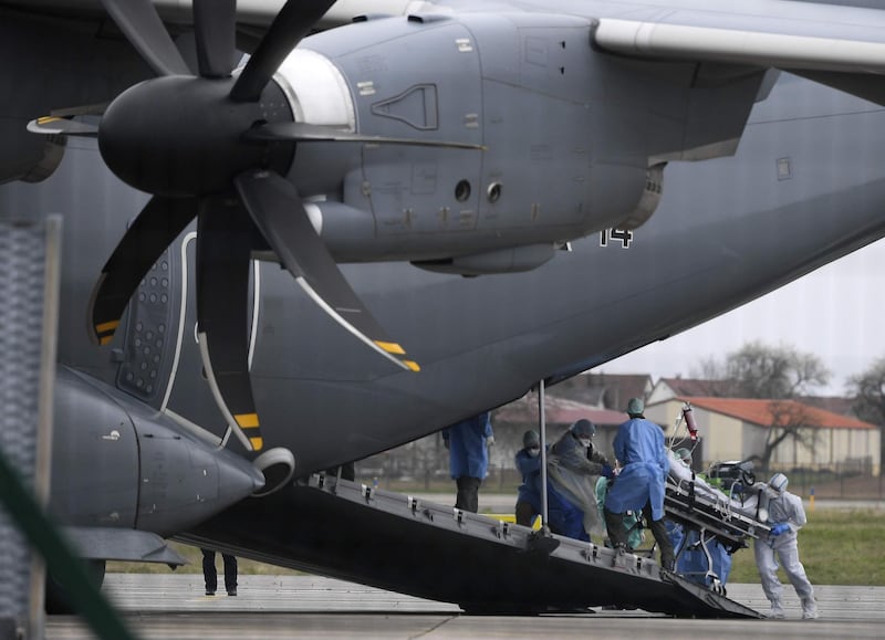 Medical staff move a patient infected with the novel coronavirus, COVID-19, into a German medicalised Airbus A400M transport plane in Strasbourg, eastern France, to be evacuated to the German cities of Stuttgart and Ulm for medical attention.  AFP
