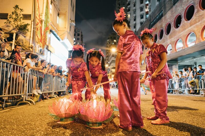 Young girls with lotus lanterns take part in the Tai Hang Fire Dragon Dance Festival.