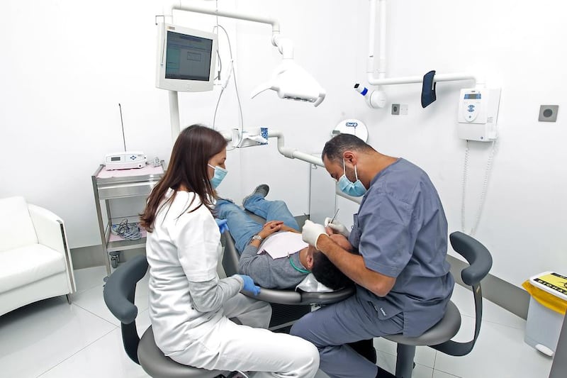 Dental cover is one of the areas being cut back by many employers in the UAE. Jeffrey E Biteng / The National