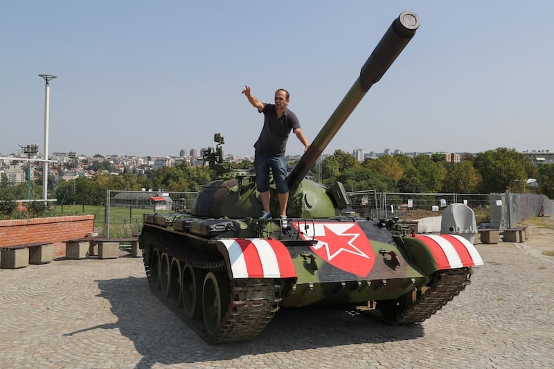 A Red Star Belgrade fan stands on the Soviet-made T-55 main battle tank in front of Rajko Mitic stadium. Reuters