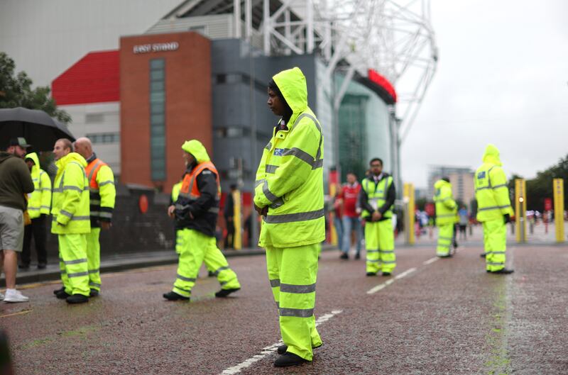 Stewards outside the stadium before the match. Action Images