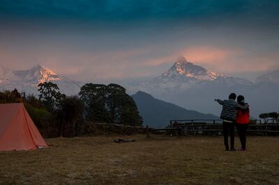 A couple enjoys the view of the Annapurna Mountain range at Australian Base Camp, one of the most famous tourist destinations in the Kaski district. EPA 