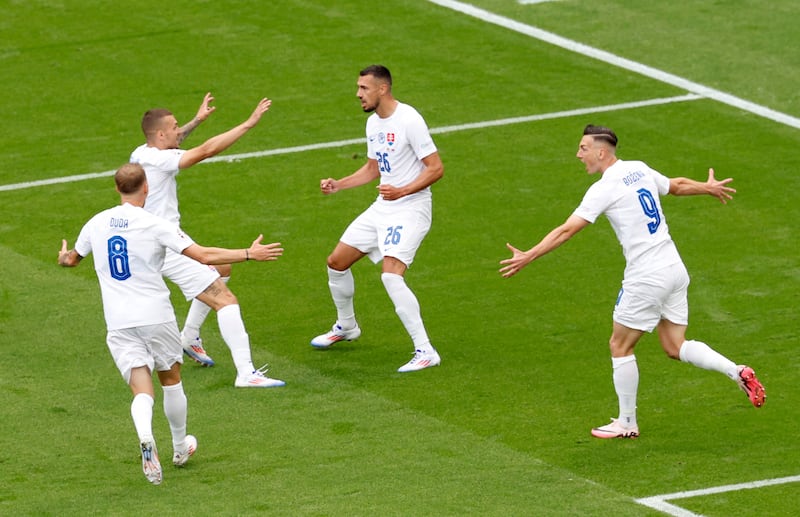 Ivan Schranz celebrates with teammates after scoring for Slovakia. Reuters