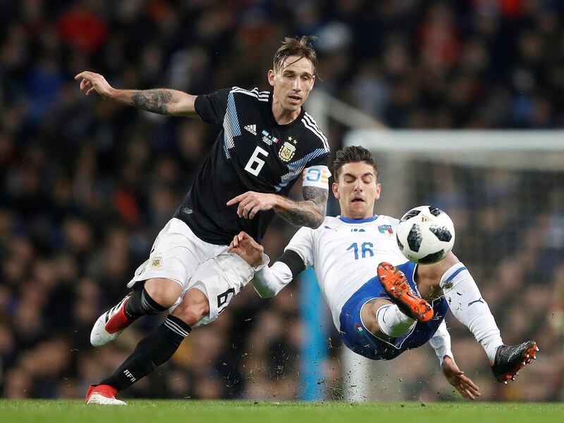 Argentina’s Lucas Biglia in action with Italy’s Lorenzo Pellegrini at the Etihad Stadium in Manchester, Britain. Action Images via Reuters / Carl Recine