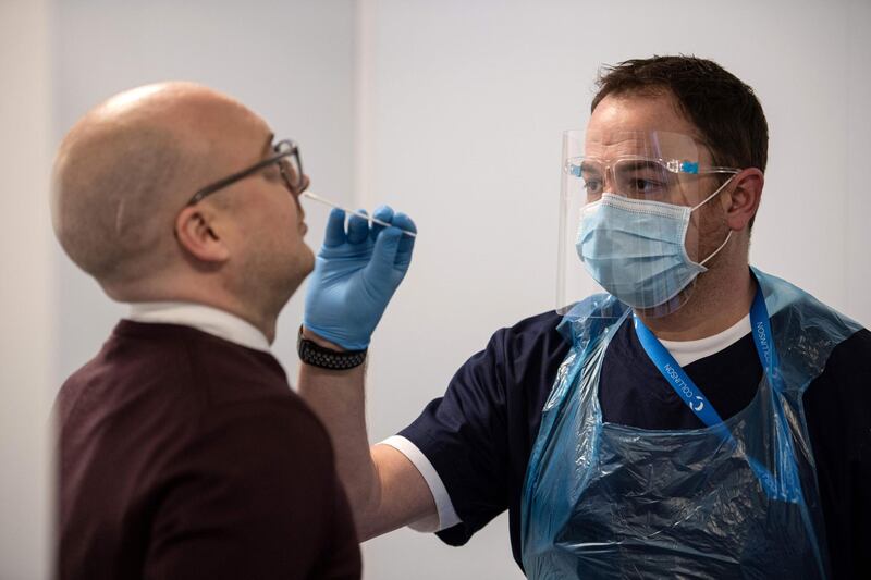 A Covid-19 test is conducted on a member of staff at Manchester Airport. AFP