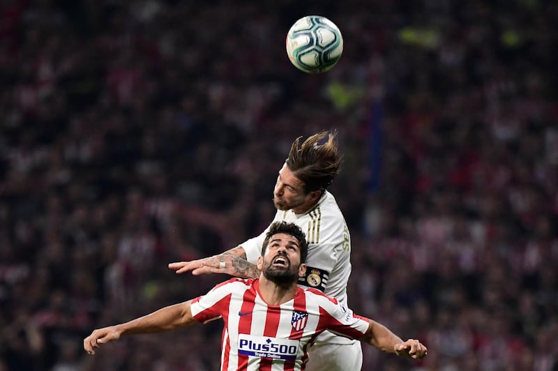 Atletico Madrid's Spanish forward Diego Costa jumps for the ball with Real Madrid's Spanish defender Sergio Ramos, top. AFP