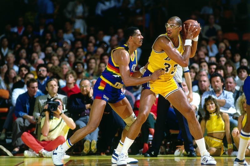 INGLEWOOD, CA  - 1986:  Kareem Abdul-Jabbar #33 of the Los Angeles Lakers posts up against Wayne Cooper #42 of the Denver Nuggets during a game played in 1986 at the Great Western Forum in Inglewood, California.  NOTE TO USER: User expressly acknowledges and agrees that, by downloading and or using this photograph, User is consenting to the terms and conditions of the Getty Images License Agreement.  Mandatory Copyright Notice:  Copyright 1986 NBAE (Photo by Andrew D. Bernstein/NBAE via Getty Images)
