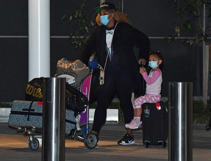 US player Serena Williams and her daughter arrive at the airport. Getty