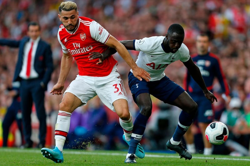 Arsenal's Sead Kolasinac tussles with Tottenham Hotspur's Davinson Sanchez. AFP
