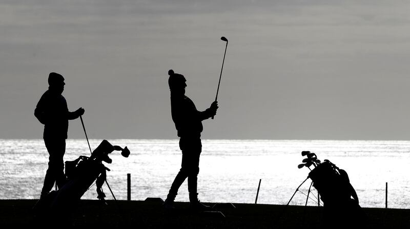 Golfers play a round of golf at Seahouses Golf Club in Northumberland. Reuters