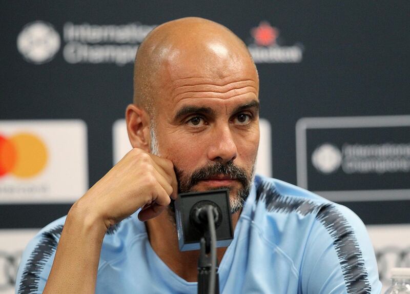 Manchester City coach, Pep Guardiola answers questions during a news conference Friday, July 27, 2018, in Miami Gardens, Fla., for Saturday's International Champions Cup soccer match between FC Bayern and Manchester City. (Pedro Portal/Miami Herald via AP)