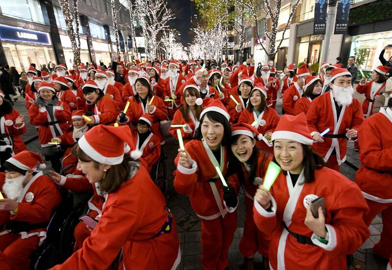 Tokyo shop workers wearing Santa Claus costumes join a Christmas parade at the Marunouchi shopping district. Toshifumi Kitamura / AFP Photo