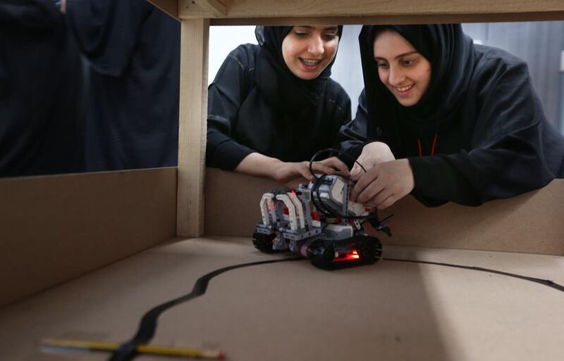 Sana Al Marzooqi, 14, left, and Eman Ahossani, 18, were teammates during the robots competition at the Stem summer camp hosted by Khalifa University. Delores Johnson / The National