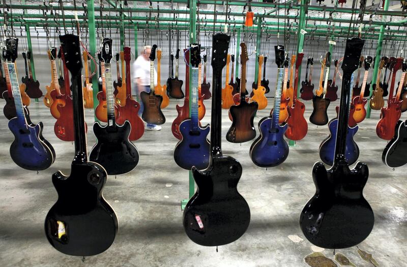 Painted guitars hang to dry after being lacquered at the Gibson USA solid-body guitar factory  in Nashville, Tenn., Friday, Oct. 7, 2011.  Recently, armed federal agents swooped into the corporate offices and Nashville factory of Gibson guitar.
Photographer:  Jeff Adkins/Bloomberg News.