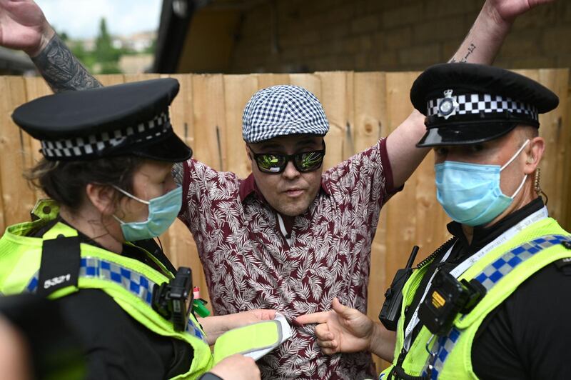 Police officers speak to a far-right protestor. AFP
