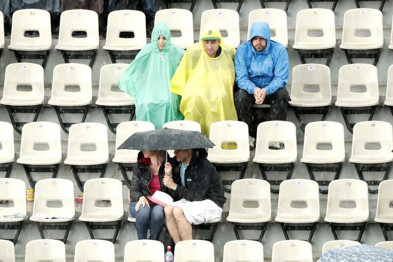 People wait in the stands of Court Suzanne Legnlen as rain interupts Alize Cornet of France against Venus Williams of the USA during their women’s single third round match at the French Open tennis tournament at Roland Garros in Paris, France, 28 May 2016.​​​​  EPA/IAN LANGSDON