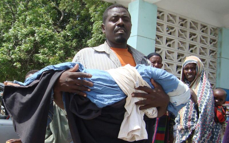 A man an from southern Somalia carries the body of his dead child from Banadir hospital in Mogadishu, Somalia, Monday, July 25, 2011. Some thousands of people have arrived in Mogadishu seeking aid and The World Food Program executive director Josette Sheeran said Saturday they can't reach the estimated 2.2 million Somalis in desperate need of aid who are in militant-controlled areas of Somalia.(AP Photo/Farah Abdi Warsameh)                