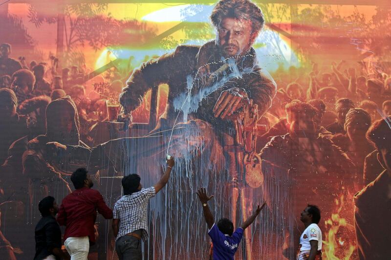 Fans of Indian movie star Rajinikanth celebrate the release of his new film "Petta" by pouring milk on his poster outside a theatre in Chennai, India. AP Photo