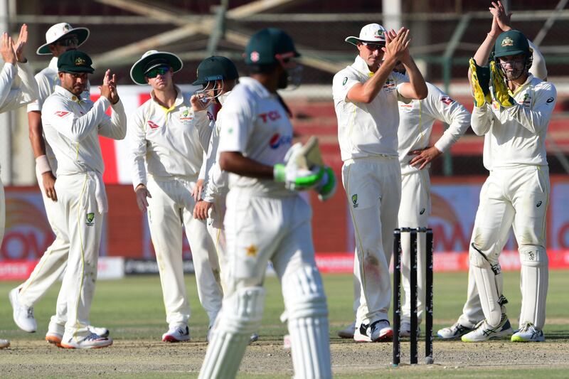 Australia players applaud as Pakistan captain Babar Azam walks back to the pavilion after his dismissal. AFP