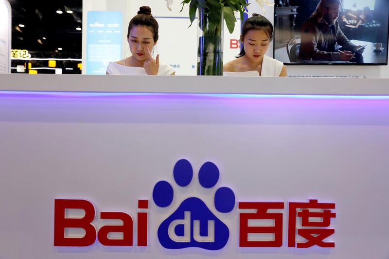 FILE PHOTO: Members of staff work at the Baidu booth during Global Mobile Internet Conference (GMIC) at the National Convention in Beijing, China April 27, 2018. REUTERS/Damir Sagolj/File Photo                  GLOBAL BUSINESS WEEK AHEAD