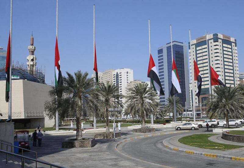 UAE flags are lowered at the Abu Dhabi Municipality offices. Ravindranath K / The National  