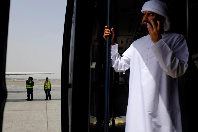 Dubai, United Arab Emirates - August 01 2013 - National reporter Thamer Al Subaihi waits in a bus after exiting the new Rotana Jet after landing in Dubai International Airport. The jet operates as a commuter flight daily between Abu Dhabi and Dubai. Four National reporters raced from Abu Dhabi to Dubai using various modes of transport to see which vehicle took the least time between two cities.  (Razan Alzayani / The National) 
