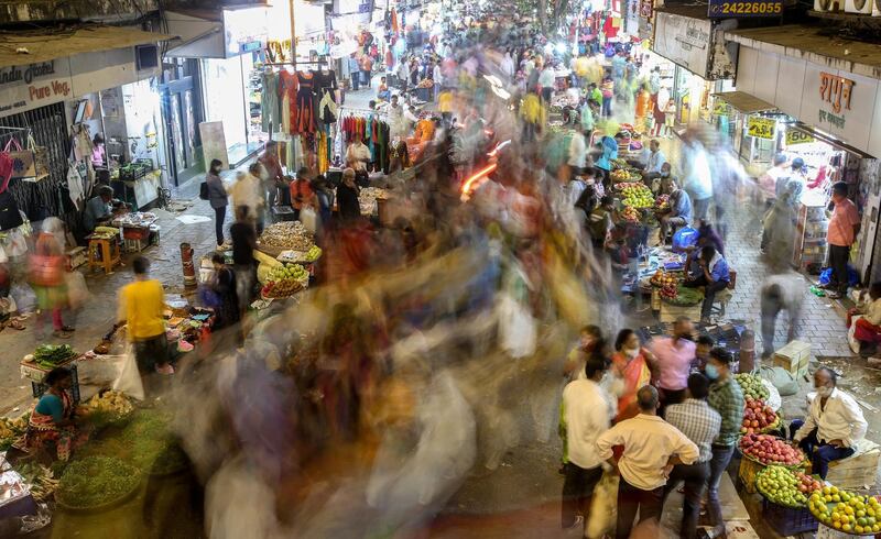 A photograph taken with slow shutter speed shows Indian people shopping at a market ahead of Diwali festival in Mumbai, India.  EPA