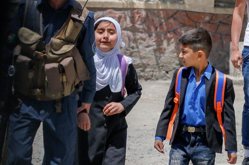 Afghan schoolchildren hurriedly leave the scene of the blast. EPA