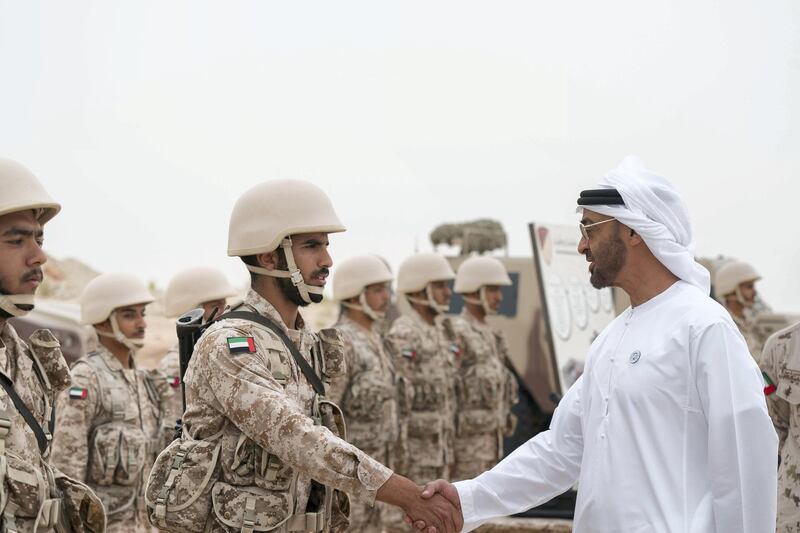 AL DHAFRA REGION, ABU DHABI, UNITED ARAB EMIRATES - April 08, 2018: HH Sheikh Mohamed bin Zayed Al Nahyan Crown Prince of Abu Dhabi Deputy Supreme Commander of the UAE Armed Forces (R) greets a member of the UAE Armed Forces, during a military exercise titled ‘Homat Al Watan 2 (Protectors of the Nation)’, at Al Hamra Camp.
 ( Mohamed Al Hammadi / Crown Prince Court - Abu Dhabi )
---
