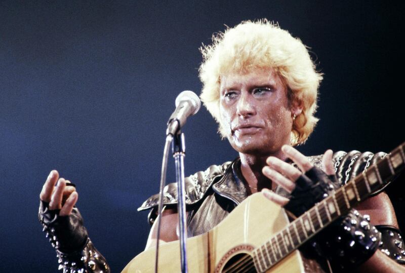 (FILES) This file photo taken on September 14, 1982 shows French singer Johnny Hallyday performing at the Palais des Sports in Paris during his show "galactique"
France's best-known rock star Johnny Hallyday has died aged 74 after a battle with lung cancer, his wife Laeticia told AFP on December 6, 2017. / AFP PHOTO / PHILIPPE BOUCHON