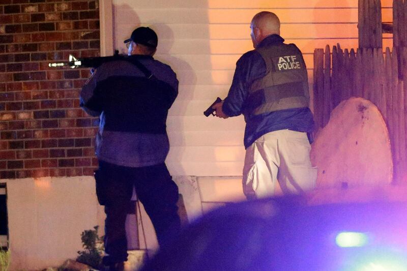 Police officers aim their weapons Friday, April 19, 2013, in Watertown, Mass. A tense night of police activity that left a university officer dead on campus just days after the Boston Marathon bombings and amid a hunt for two suspects caused officers to converge on a neighborhood outside Boston, where residents heard gunfire and explosions.(AP Photo/Matt Rourke) *** Local Caption ***  Police Converge Mass.JPEG-03d0d.jpg