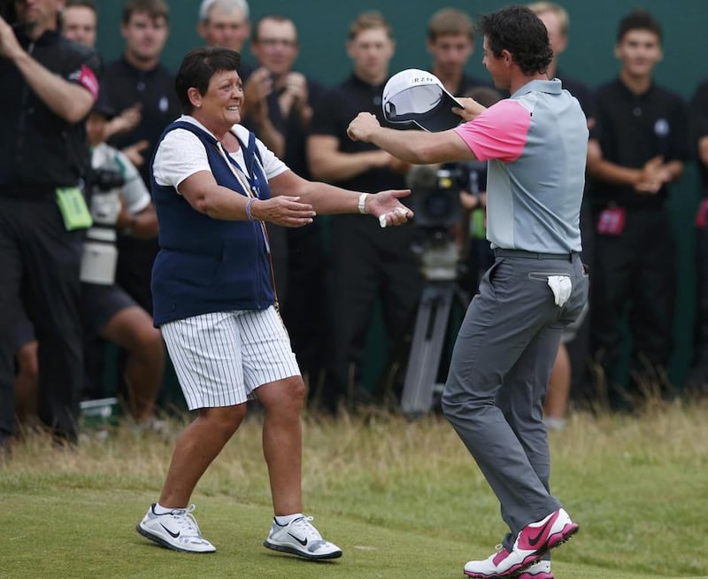 Rory McIlroy celebrates with his mother Rosie on the 18th green after winning the British Open on Sunday. Cathal McNaughton / Reuters