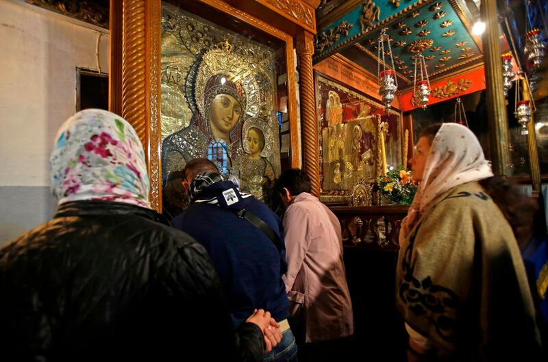 Christian pilgrims visit the Church of the Nativity, the site where Christians believe Jesus was born, in the biblical West Bank city of Bethlehem on December 24, 2019.  / AFP / Musa Al SHAER

