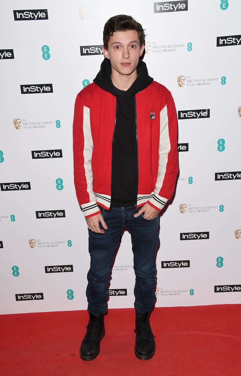 Tom Holland, in jeans, a black hoodie and Fila jacket, attends the EE InStyle Party in London on February 6, 2018. Getty Images