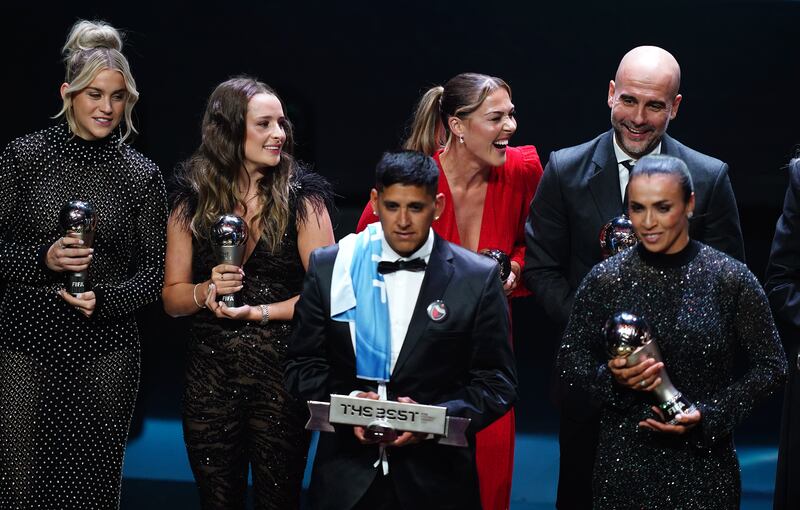 Back row, left to right, Alessa Russo, Ella Toone, Mary Earps and Pep Guardiola on stage with their trophies at the end of the show, during The Best Fifa Football Awards at the Eventim Apollo, London. PA