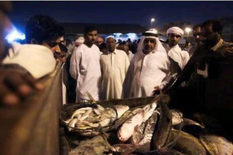 Mohammed Saif Al Suwaidi, manager of Dubai Fishermen's Cooperative Association, educates trainee inspectors about catches at the fish market in Deira.