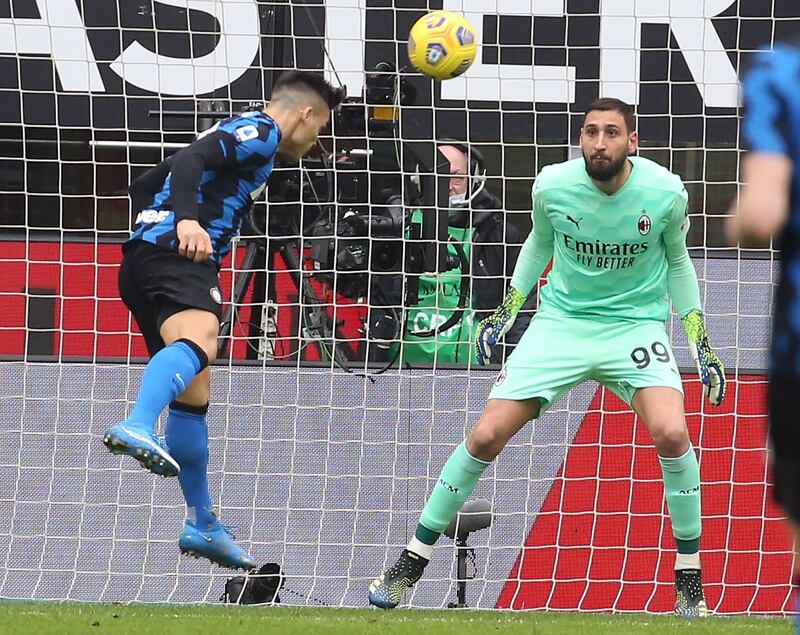 Lautaro Martinez heads past AC Milan goalkeeper Gianluigi Donnarumma to put Inter 1-0 up. EPA