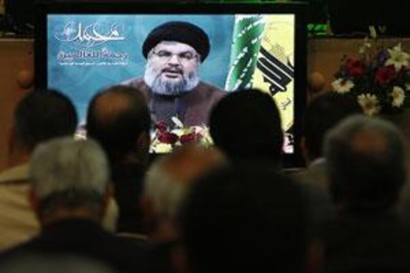 Lebanese Hezbollah supporters listen to Hassan Nasrallah who speaks via a video link from a secret location through a giant screen, in the southern suburb of Beirut, Lebanon, on March 13 2009.