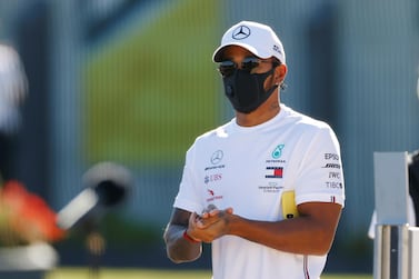 Formula One F1 - British Grand Prix - Silverstone Circuit, Silverstone, Britain - July 30, 2020 Mercedes' Lewis Hamilton washes his hands as he wears a protective face mask in the paddock ahead of the British Grand Prix REUTERS/Andrew Boyers