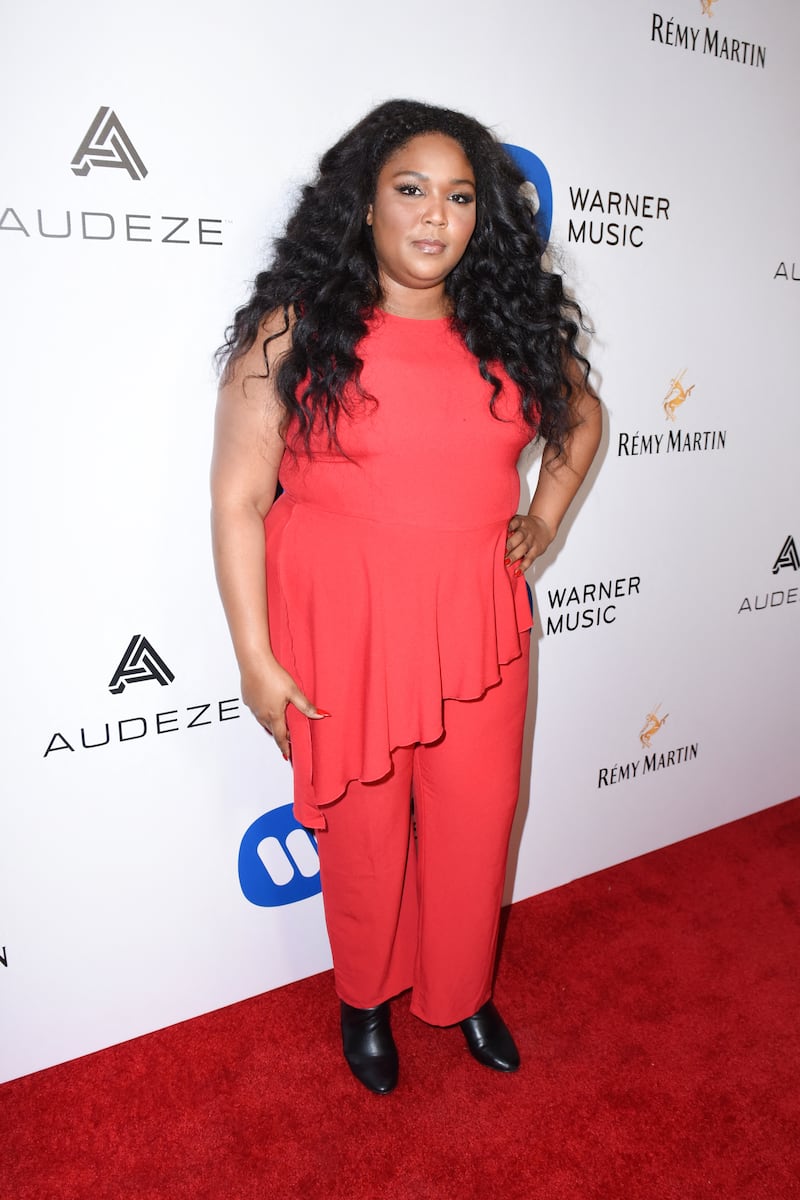 Lizzo wears a loose-fitting coral, floor-length dress at an event in Hollywood, California, in 2017. Getty Images