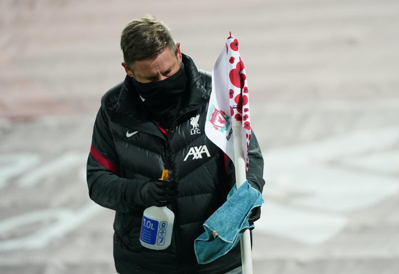 A member of staff cleans a corner flag at half time. Reuters