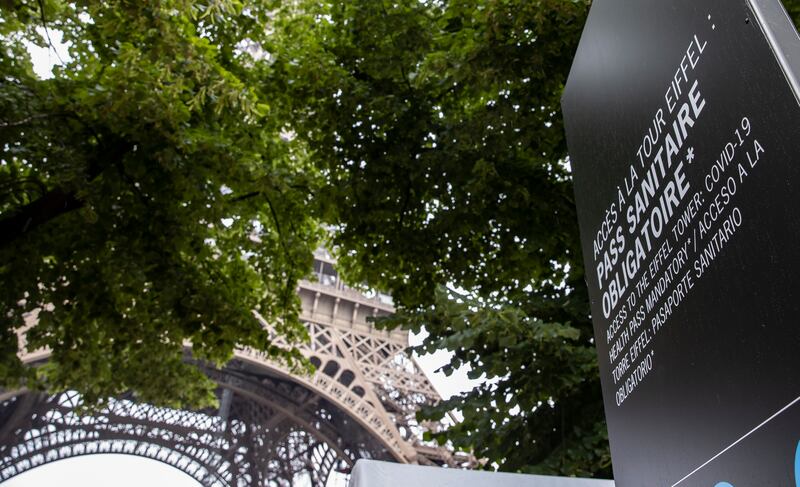 A sign indicates that a health pass is required to access the Eiffel Tower in Paris. EPA