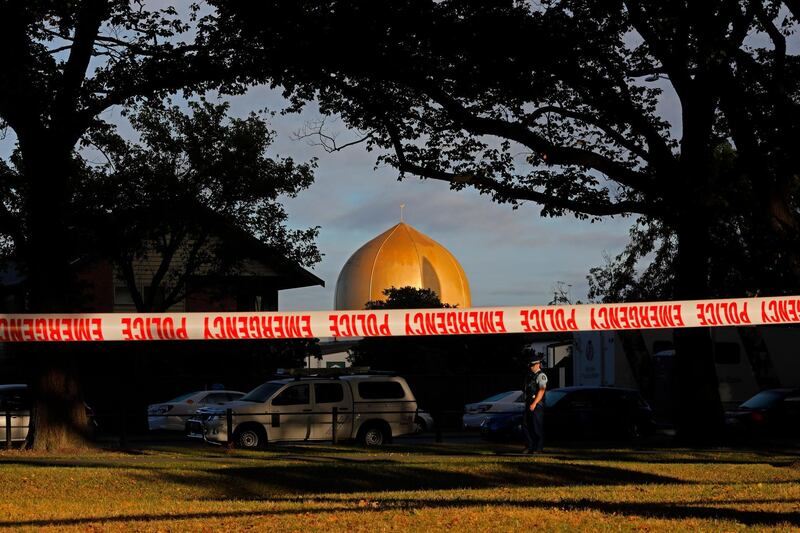 FILE - In this March 17, 2019, file photo,  police officer stands guard in front of the Masjid Al Noor mosque in Christchurch, New Zealand, where one of two mass shootings occurred. A New Zealand man is facing criminal charges after allegedly posting online threats against two Christchurch mosques that were the sites of a terrorist attack that left 51 people dead.
Police on Thursday, March 4, 2021, arrested the 27-year-old man and charged him with threatening to kill. If found guilty, he faces a maximum prison sentence of seven years. (AP Photo/Vincent Yu, File)