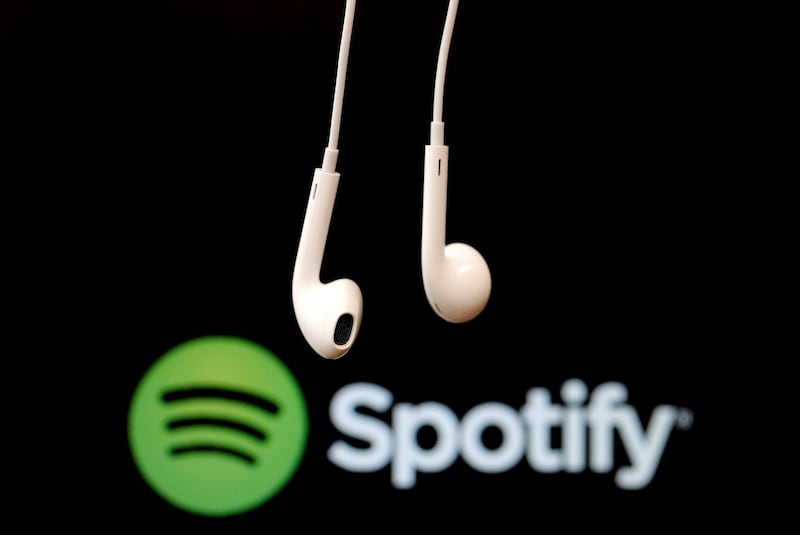 FILE PHOTO: Headphones are seen in front of a logo of online music streaming service Spotify,  February 18, 2014 REUTERS/Christian Hartmann/File Photo