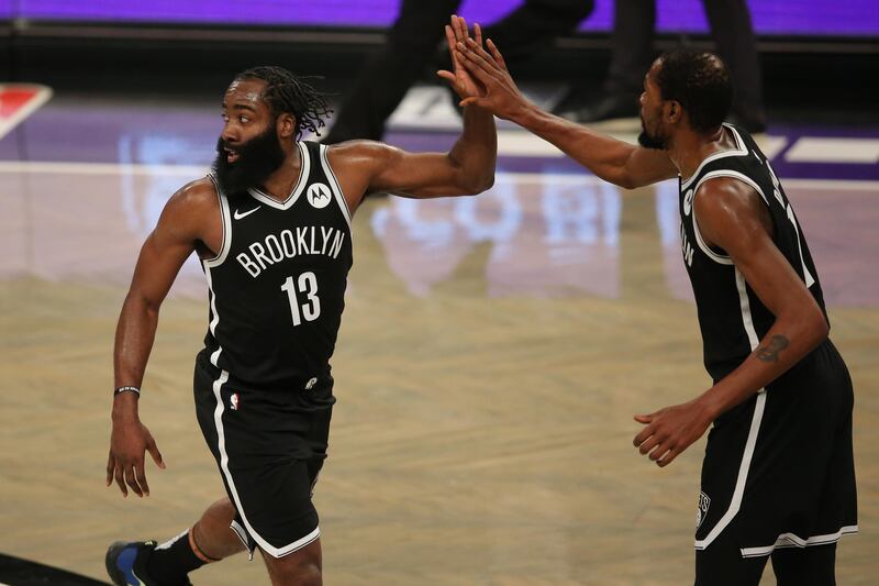 Jan 18, 2021; Brooklyn, New York, USA; Brooklyn Nets shooting guard James Harden (13) and power forward Kevin Durant (7) high five during the fourth quarter against the Milwaukee Bucks at Barclays Center. The Nets defeated the Bucks 125-123. Mandatory Credit: Brad Penner-USA TODAY Sports