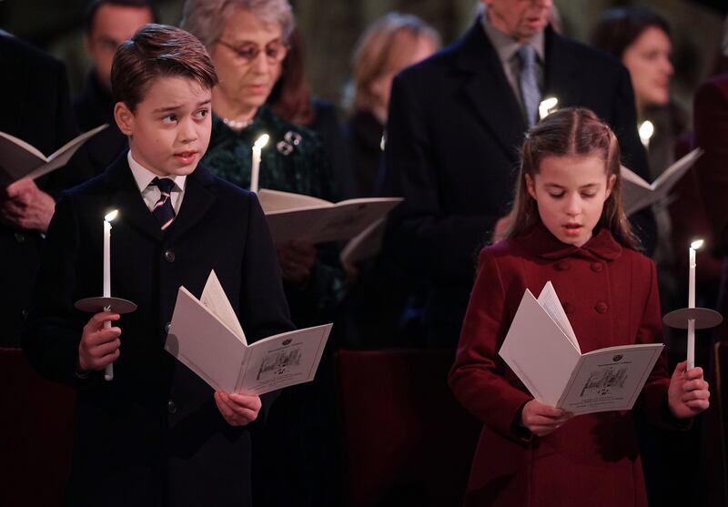 LONDON, ENGLAND - DECEMBER 15: In this photo released on December 24, Prince George and Princess Charlotte are seen during the 'Together at Christmas' Carol Service at Westminster Abbey on December 15, 2022 in London, England.  The service will be broadcast on ITV1 on Christmas Eve as part of a Royal Carols: Together At Christmas programme, narrated by Catherine Zeta Jones and featuring an introduction by Catherine, Princess of Wales and tributes to Queen Elizabeth II. (Photo Yui Mok - Pool / Getty Images)